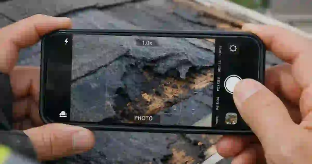 Roofing contractor reviewing an actual cash value roof claim quote after hail damage